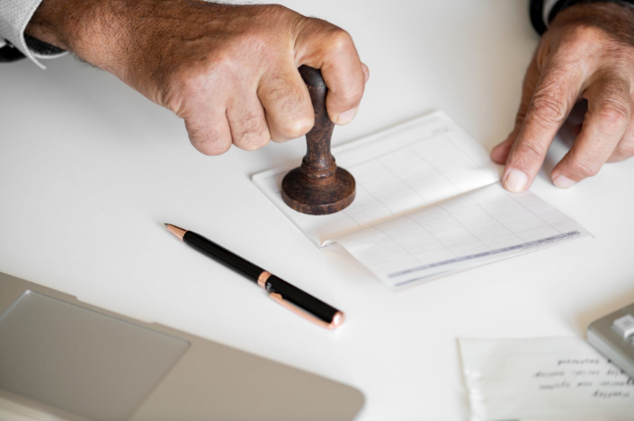 a person stamping a bank book